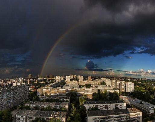 Overview of city of Zagreb with clouds and rainbow